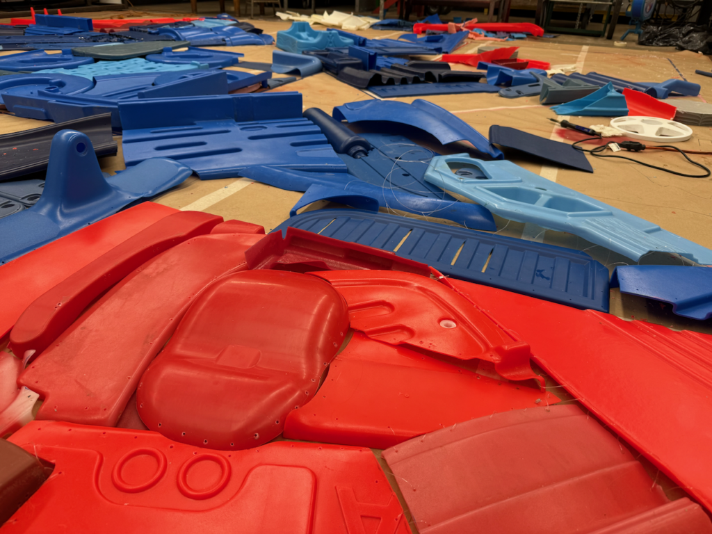 This image has an empty alt attribute; its file name is IMG_6573-1024x768.png
Progress image of It's in the Water, which entails stitching together pieces of discarded plastic (mainly children's outdoor playground toys). The sculpture will form a red, white and blue quilt motif like those found on many barns across Iowa